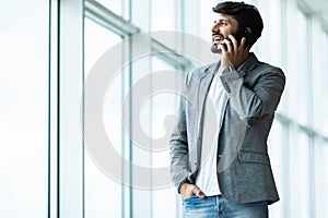 Young business man talk phone in modern office