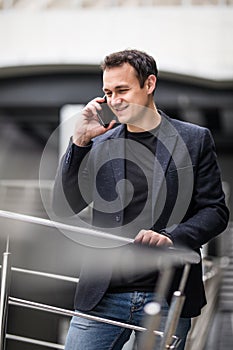 Young business man talking on cell phone at modern office