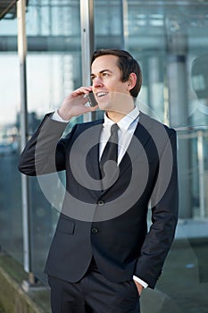 Young business man talking on mobile phone outdoors