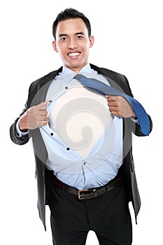 Young business man tearing off his shirt