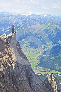 Young business man on top of mountain