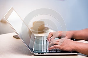 Young business man typing laptop