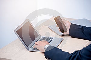 Young business man typing laptop