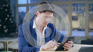 Young business man use modern device for reading photo