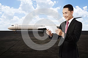Young business man using his tablet on the airport