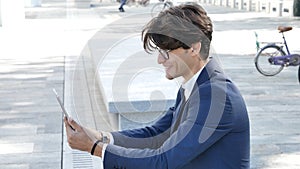 Young business man using tablet computer outdoor