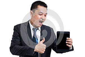 Young business man wear black suit working on digital tablet. Businessman hand holding tablet and hand thumbs up.