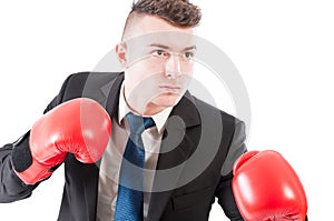 Young business man wearing boxing gloves