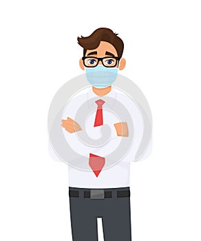 Young business man wearing medical mask to prevent disease and standing crossed arm. Trendy person covering surgical face mask