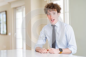 Young business man wearing a tie afraid and shocked with surprise expression, fear and excited face