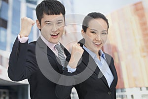 Young business man and woman cheering