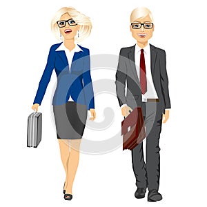 Young business man and woman walking forward