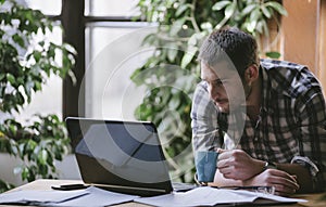 Young business man work on computer in his pleasant studio home