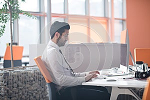 Young business man working on desktop computer