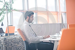 Young business man working on desktop computer