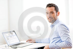 Young business man working at home on his laptop