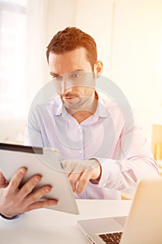 Young business man working at home on his laptop