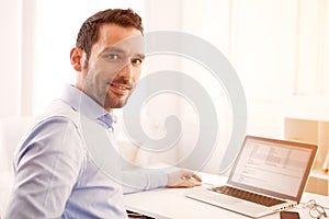 Young business man working at home on his laptop