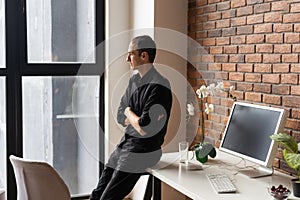 Young business man working at home with laptop on desk