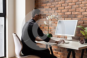 Young business man working at home with laptop on desk