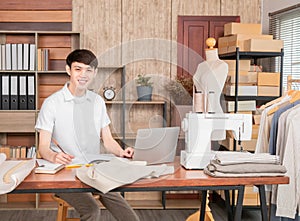 Young Business owner working fashion designer using laptop for find new collection dress, Asian man work from home design on