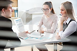 Young business people discussing a new project at a meeting