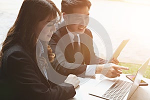 young business people having a meeting. businessman & businesswoman working with computer at cafe. startup man & freelance woman