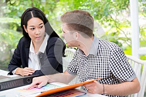 Young business people making meeting and looking at document for analyzing marketing working at office