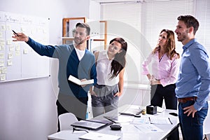 Young Business People Near Scrum Task Board In Office photo