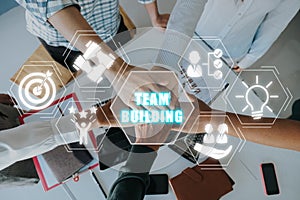 Young business people putting their hands together with team building icon on virtual screen, Stack of