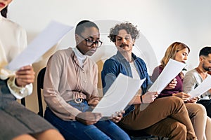 Young business people sitting in chairs and waiting for an interview