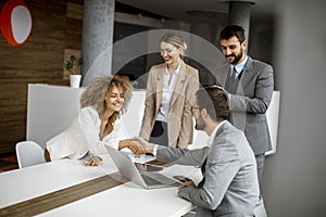 Group of young business people making a deal at a meeting in the office