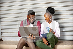 Young business people with a laptop and having coffee