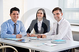 Young business people smiling looking at camera