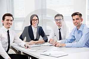 Young business people smiling looking at camera photo