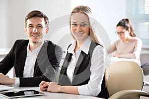 Young business people smiling looking at camera photo
