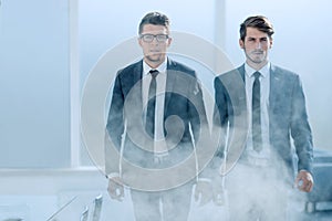 Young business people in a smoky office