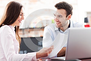 Business people using laptop at cafe