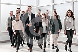 Young business people walking together in a new office