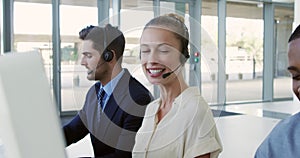 Young business people wearing headsets in a modern office