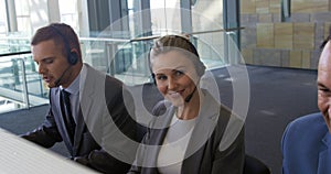 Young business people wearing headsets in a modern office