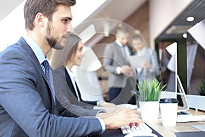 Young business people working on their desktop computers at the modern office space