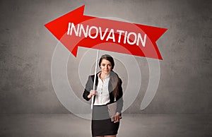 Young business person in casual holding road sign