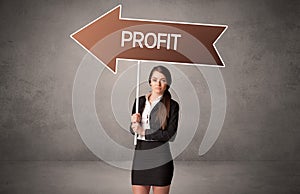 Young business person in casual holding road sign