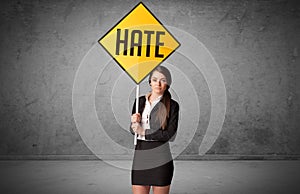 Young business person holding road sign