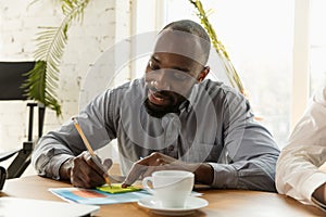 Young business professional preparing for meeting, creative office