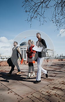 Young business professionals strategizing outdoors in a city setting