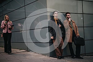 Young business professionals taking a break outside the office building