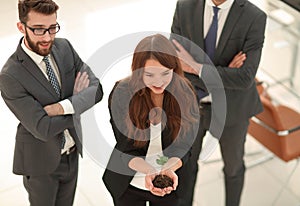 Young business team with fresh sprouts