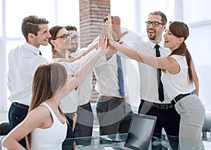 Young business team giving each other high five